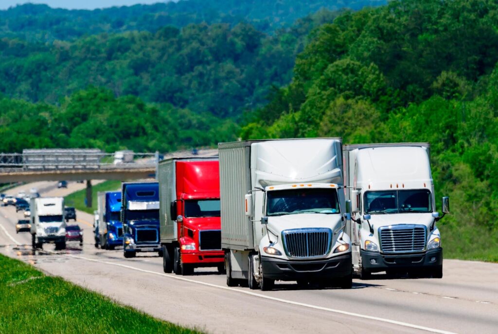 fleet of trucks driving down the road